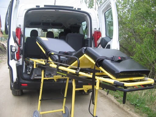Stretcher prepared at the tailgate of a transport van before a stretcher trip