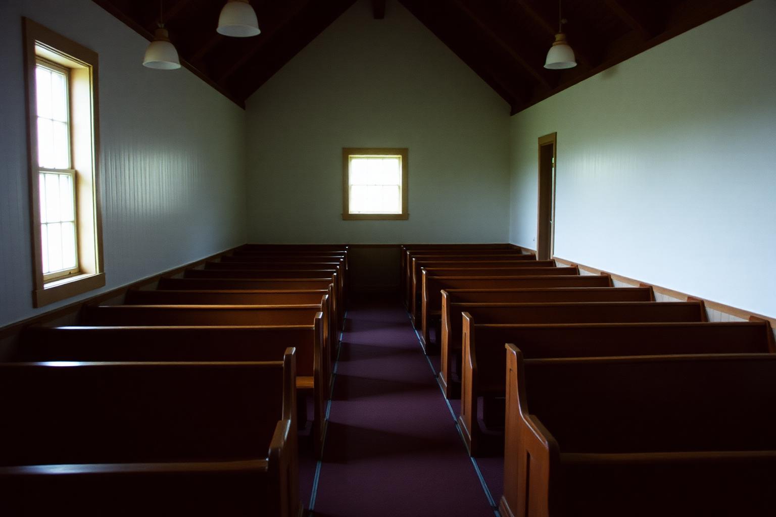Empty wooden pews lit by morning daylight